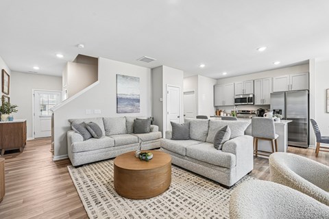 A modern living room with a grey couch and a coffee table.