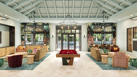 A room with a pool table and couches.