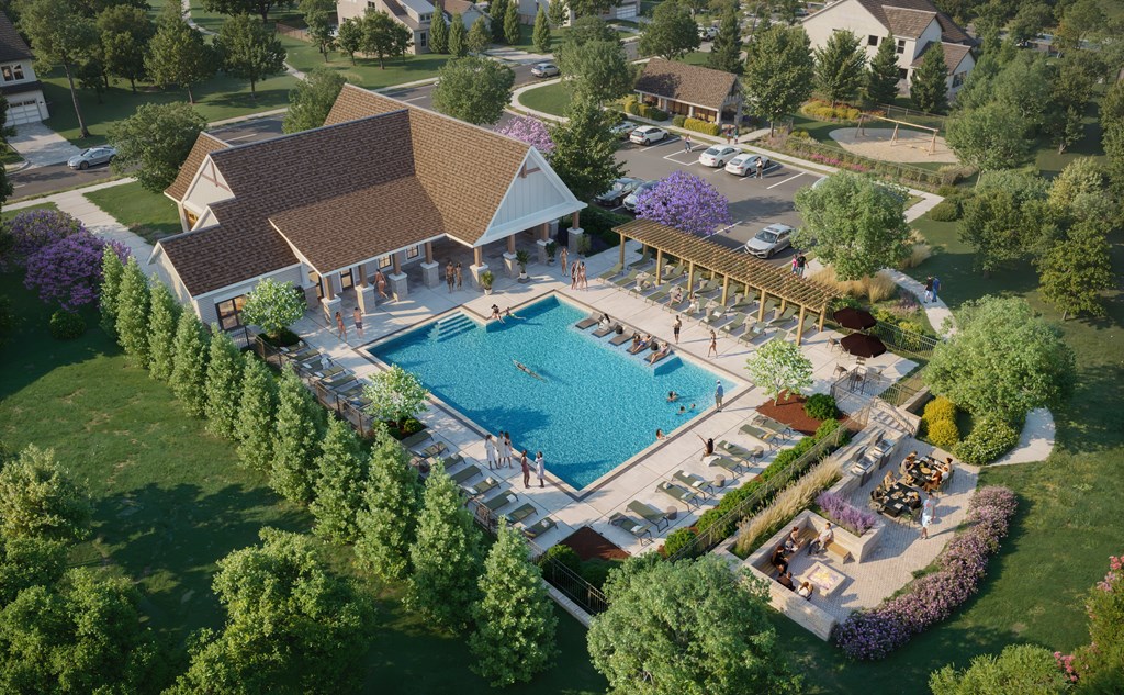 A large outdoor swimming pool surrounded by trees and a pavilion.