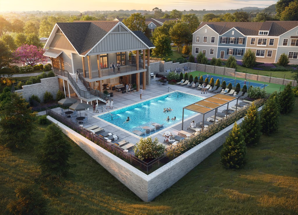 A large outdoor swimming pool surrounded by lounge chairs and a building in the background.