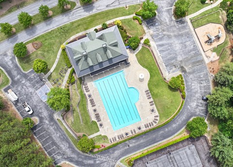 A large building with a pool in front of it.