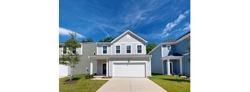 A two-story house with a garage and a driveway.