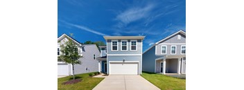 A house with a garage door in the center.
