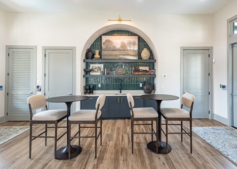 A dining room with a table and chairs.