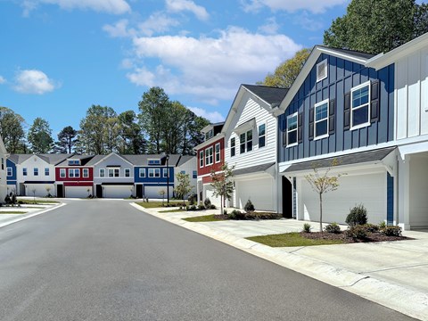 A street view of a residential area with houses on both sides.