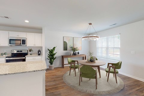 A modern kitchen with a dining table and chairs.