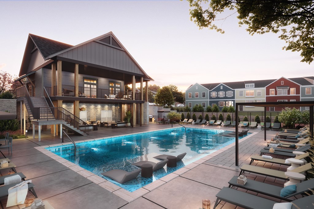 A large house with a pool in front.