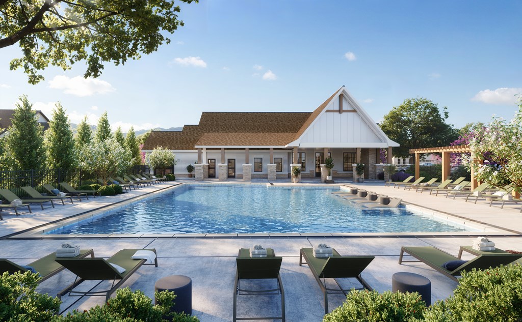 A large swimming pool surrounded by lounge chairs and trees.