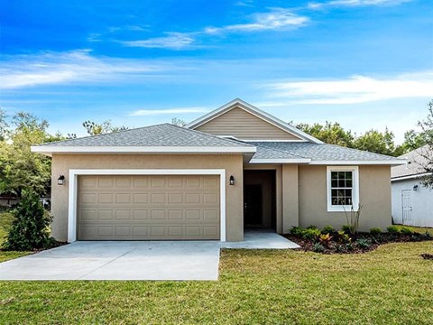 a house with a garage door and a driveway