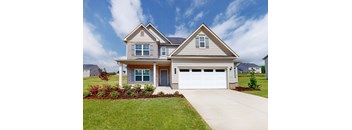 A two-story house with a garage and a driveway.