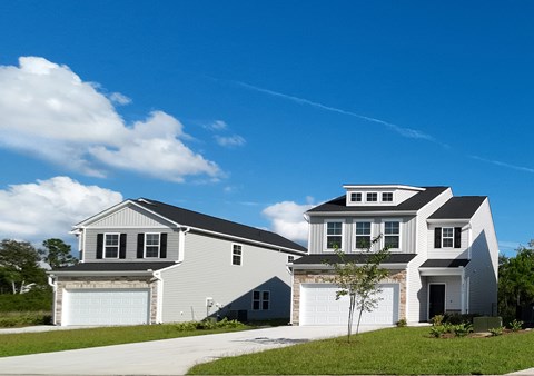 A two-story house with a garage on the ground floor and a living area on the upper floor.