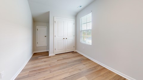 A room with a white door and a white cabinet.