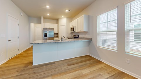 A kitchen with a white counter and cabinets.