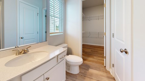 A bathroom with a white toilet and a sink.