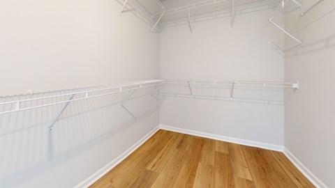 Empty room with white walls and wooden floor.
