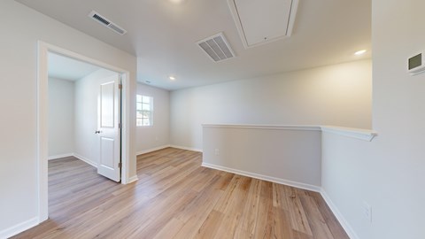 A room with wooden floors and white walls.
