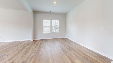 A room with wooden flooring and a window.