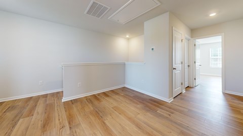 A room with wooden floors and white walls.