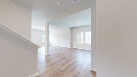 A room with wooden floors and white walls.