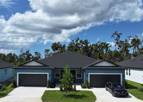 A house with a car parked in front.