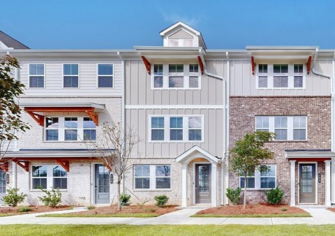 A row of townhouses with different colored trim.