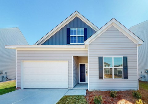 A modern house with a grey exterior and a white garage door.