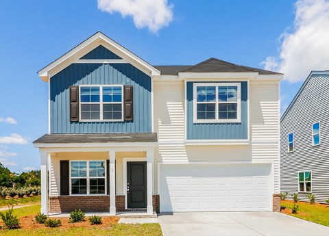 A two-story house with a blue and white exterior.