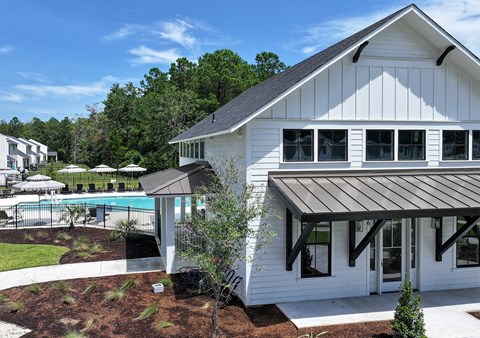 A white house with a pool in the backyard.