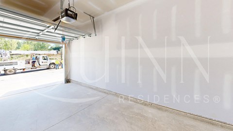 a garage with a large window and a truck in the door