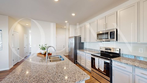 a kitchen with granite counter tops and stainless steel appliances