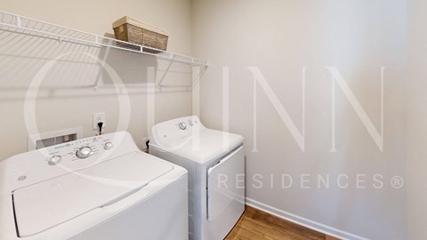 a washer and dryer in a laundry room with a sink