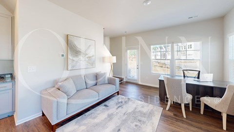 a living room and dining room with a couch and a table