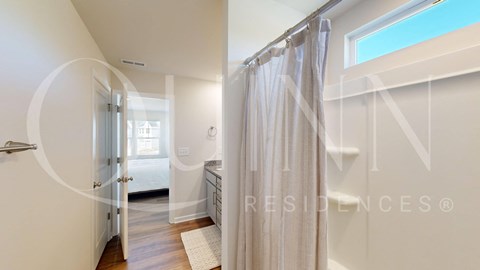 a bathroom with a shower and a white shower curtain