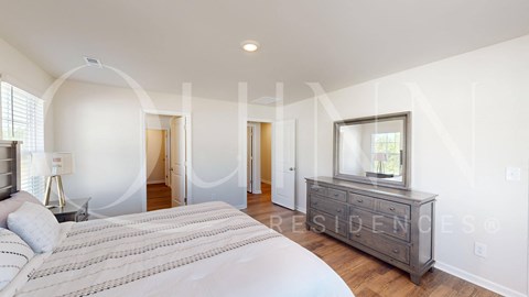 a bedroom with a bed and a dresser