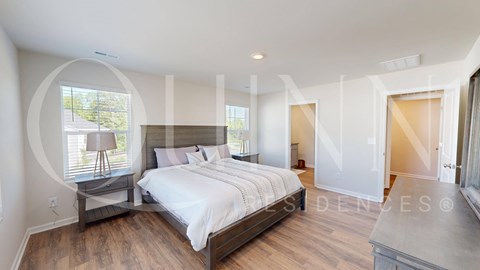 bedroom with a large bed and a mirrored closet