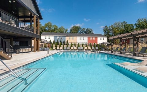 A large swimming pool with a building in the background.