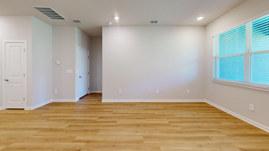 A room with wooden floors and white walls.