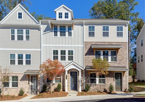 A modern two-story house with a mix of grey and beige siding.