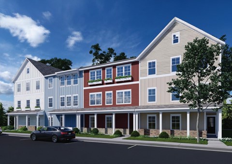 A modern two story house with a car parked in front.