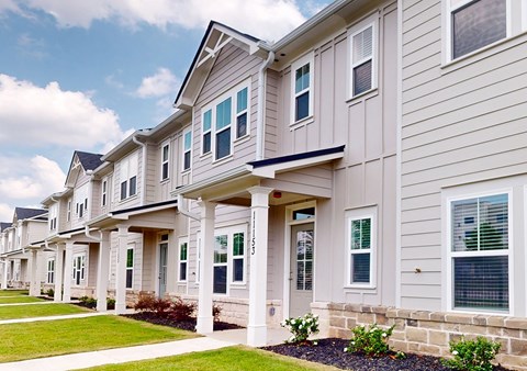 A row of houses with a blue sky in the background.