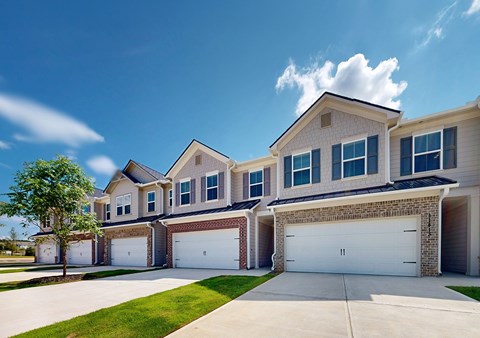 A row of houses with garages in front.