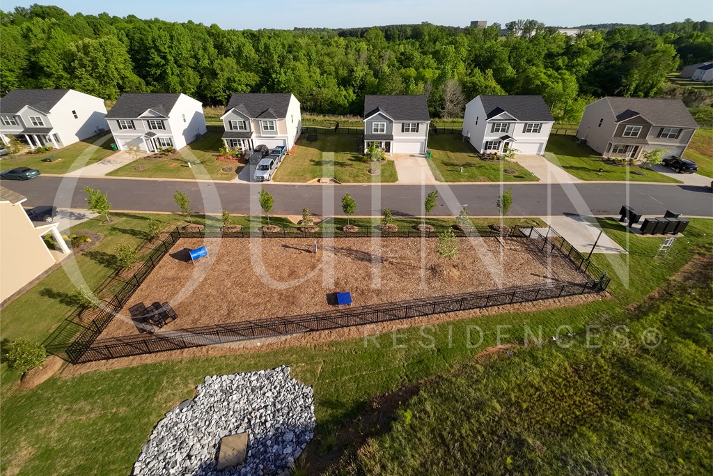 an aerial view of a yard with a tennis court and houses
