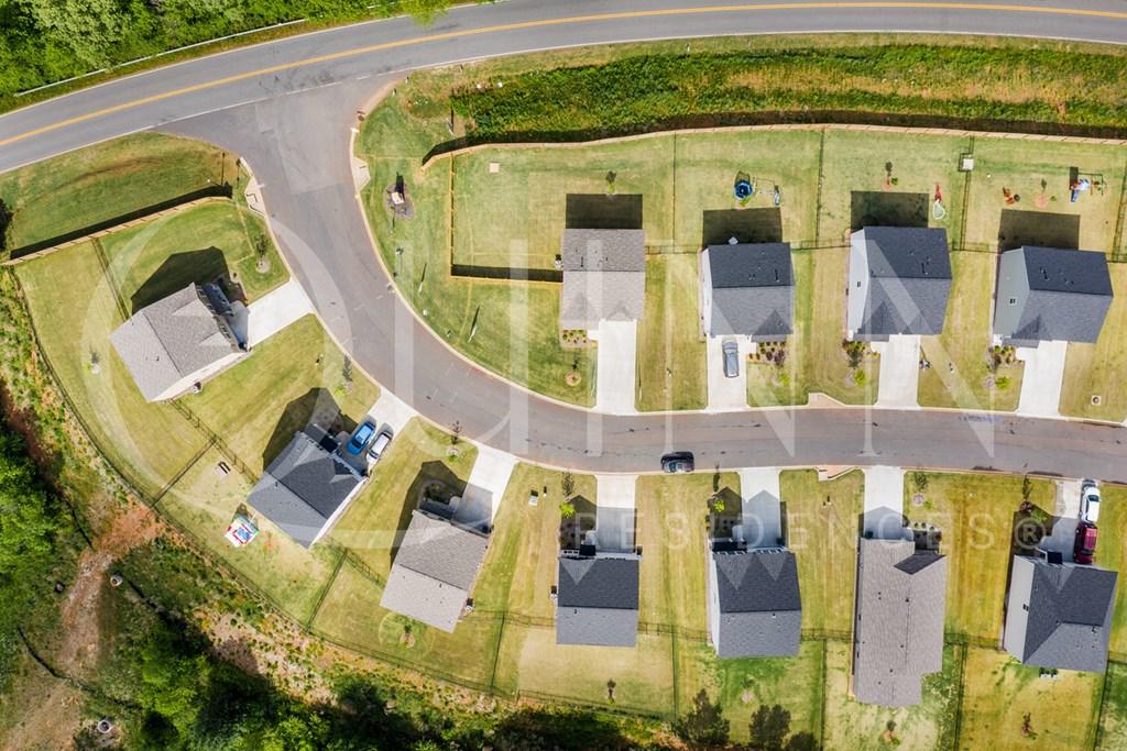 a birdseye view of a neighborhood with houses and a road