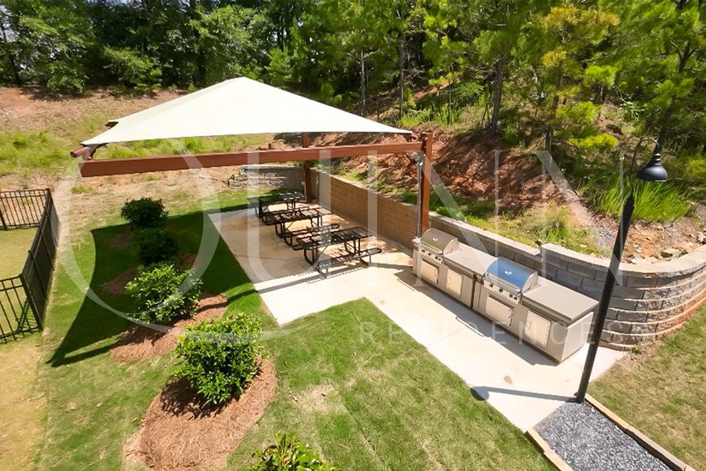 a backyard with a picnic table and a patio