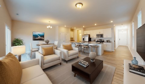 A modern living room with white furniture and a flat screen TV.