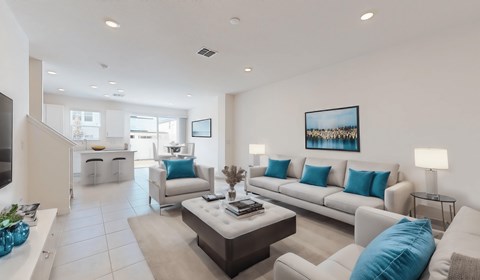 A living room with a white couch and a coffee table.