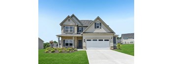 A two-story house with a garage and a driveway.