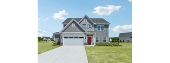 A two-story house with a garage and a red door.