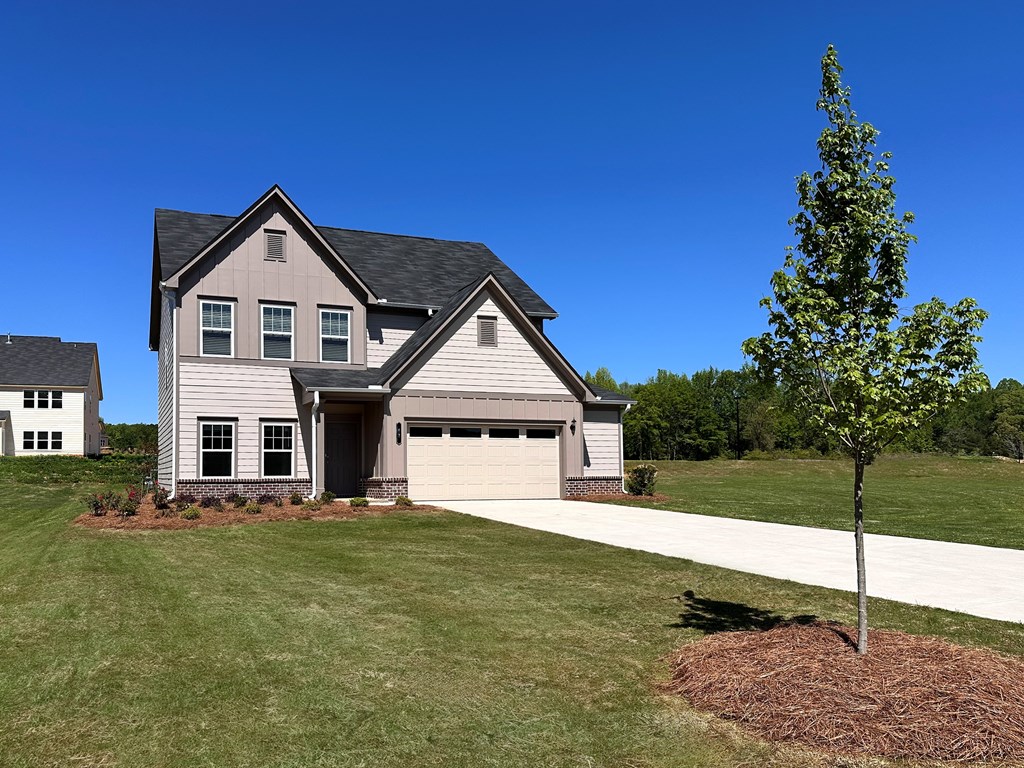 A house with a tree in front of it.