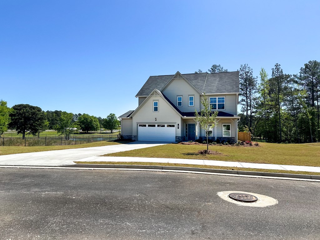 A house with a grey roof and a white garage door.